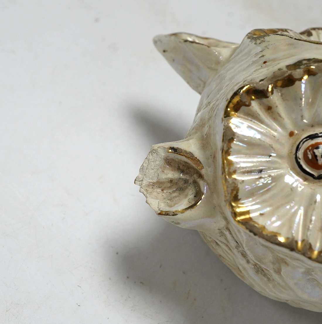 From the Studio of Fred Cuming. A ceramic lustre owl raised on circular base. Condition - (a.f.)